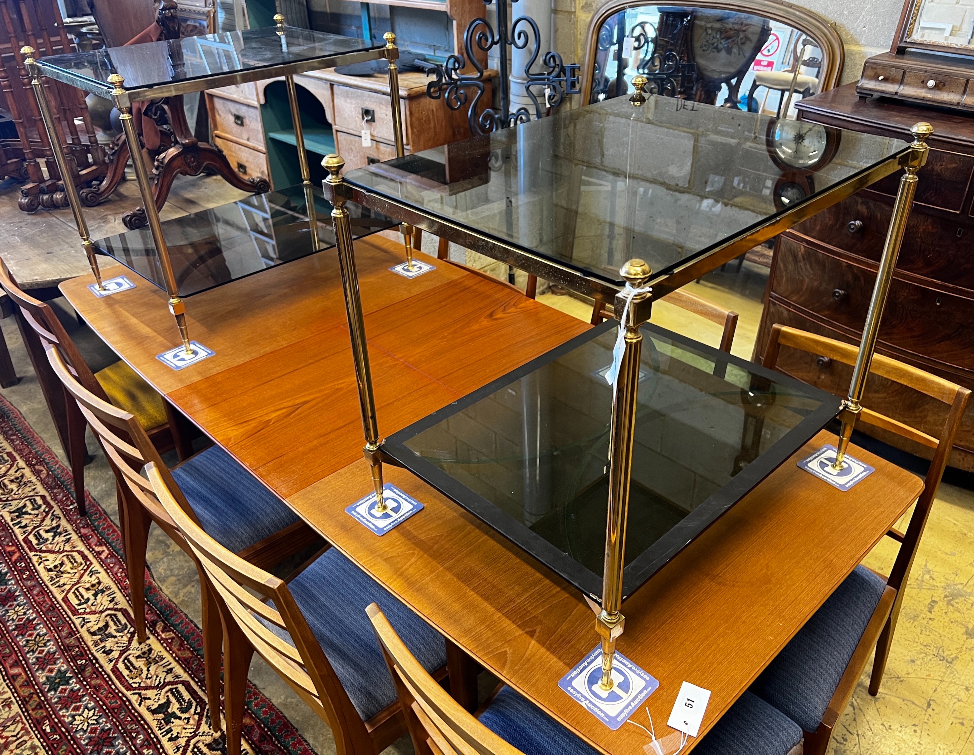 A pair of rectangular brass and black glass two tier tables, width 65cm, depth 50cm, height 59cm